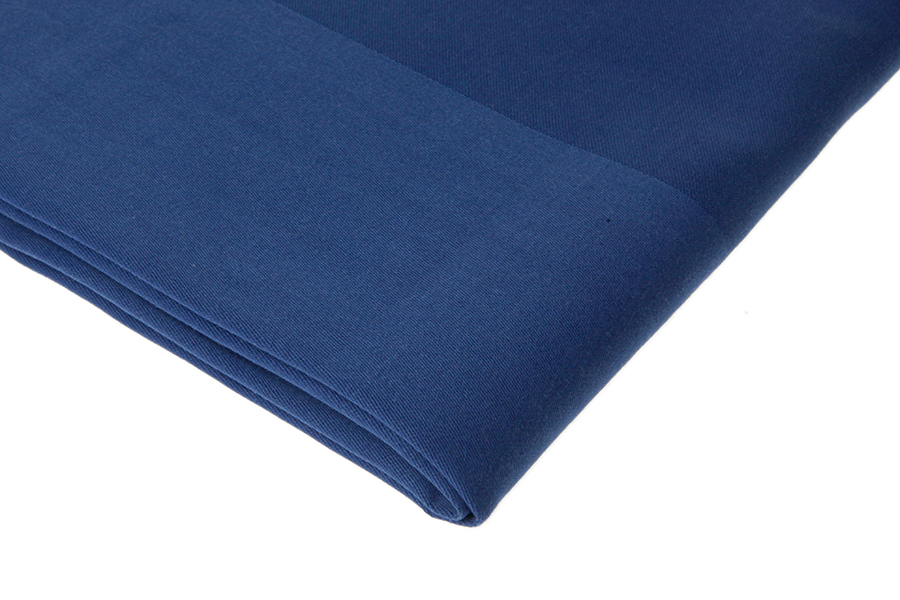 Eight shirts arranged on table in black, olive, grey, blue, white, red, mustard, and green.